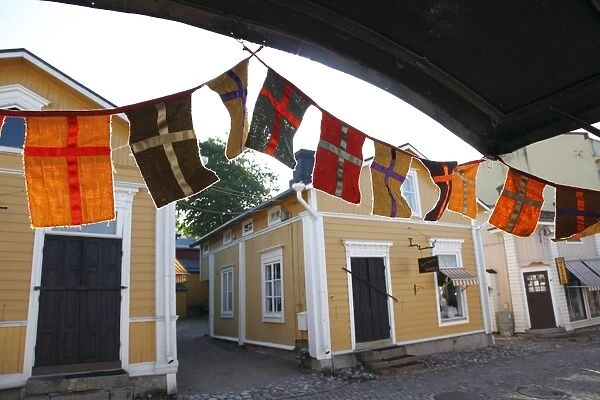 Decorative flags and medieval wooden houses, Porvoo, Uusimaa, Finland, Scandinavia