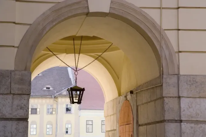 Framed Print : Decorative lantern hanging under an archway in the old towns main square Framed Print : Decorative lantern hanging under an archway in the old towns main square