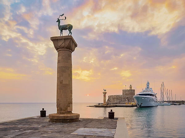 Deer and Doe on columns at entrance to Mandraki Harbour, former Colossus of Rhodes location, Saint Nicholas Fortress in the background, sunrise, Rhodes City, Rhodes Island, Dodecanese, Greek Islands, Greece, Europe