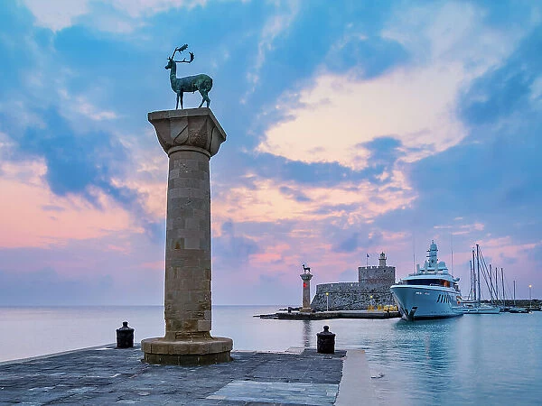 Deer and Doe on columns at the entrance to Mandraki Harbour, former Colossus of Rhodes location, Saint Nicholas Fortress in the background, sunrise, Rhodes City, Rhodes Island, Dodecanese, Greek Islands, Greece, Europe