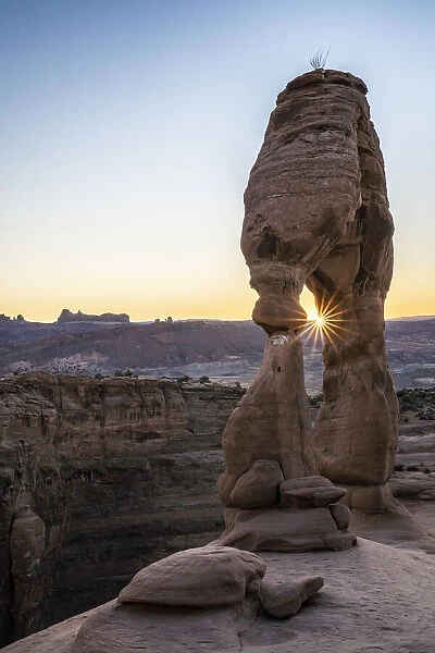 Delicate Arch at sunset with sunburst, Arches National Park, Utah