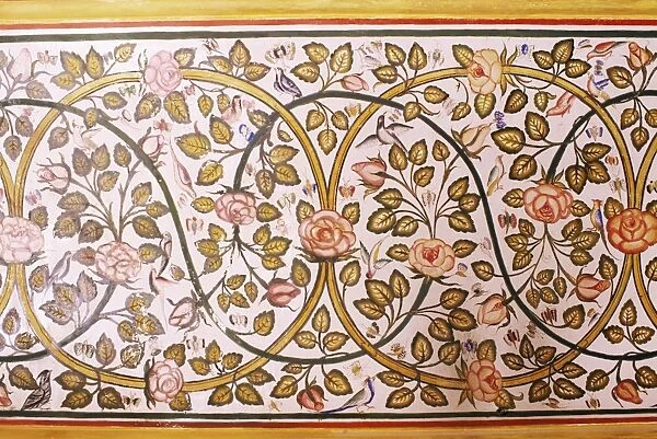 Depiction of rose and birds painted on wall in dining area