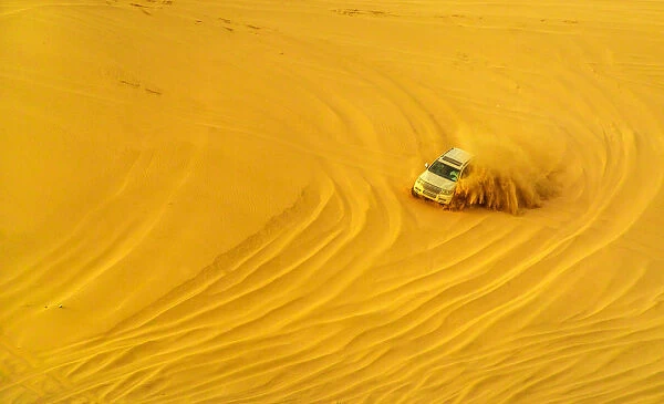 Desert safari adventure in 4x4 vehicle bashing side to side through the desert dunes