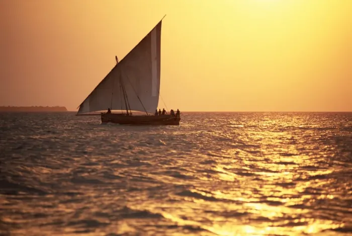 Framed Print : Dhow in silhouette on the Indian Ocean at sunset, off Stone Town, Zanzibar