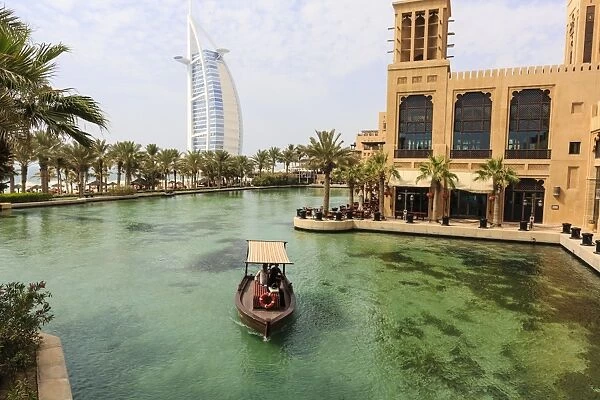 Dhows cruise around the Madinat Jumeirah Hotel with Burj Al Arab in the background, Dubai, United Arab Emirates, Middle East