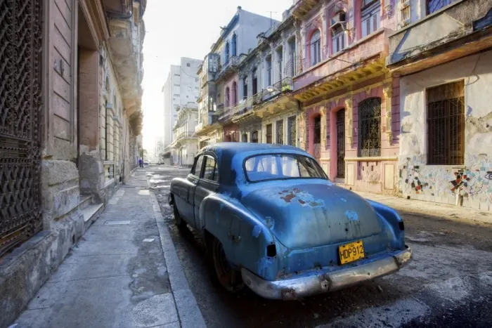 Framed Print : Dilapidated American car parked on a street of ornate colonial buildings Framed Print : Dilapidated American car parked on a street of ornate colonial buildings