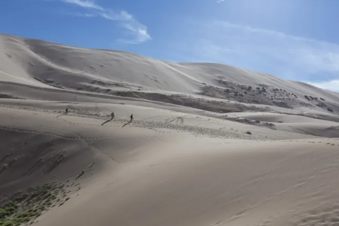 Framed Print : Distant people descending a huge sand dune, iridescent on a summer evening, Khongoryn Els Framed Print : Distant people descending a huge sand dune, iridescent on a summer evening, Khongoryn Els