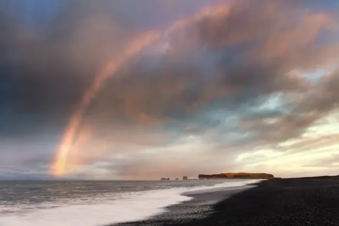 Framed Print : Distant view of Dyrholaey at sunrise with rainbow, from Halsanefs Hellir Beach near Vik Framed Print : Distant view of Dyrholaey at sunrise with rainbow, from Halsanefs Hellir Beach near Vik