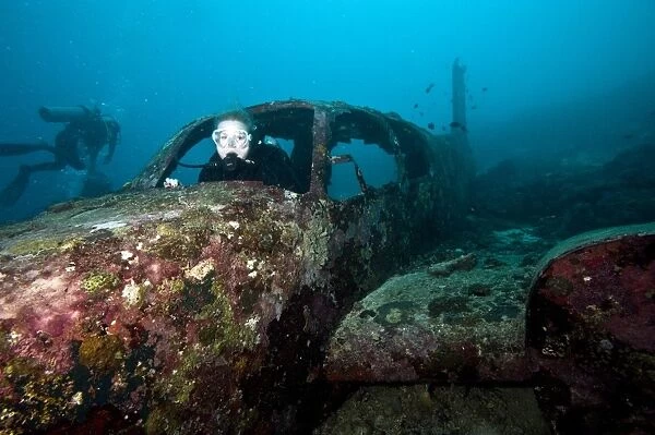 Diver inside the wreck of a four seater airplane, Philippines, Southeast Asia, Asia