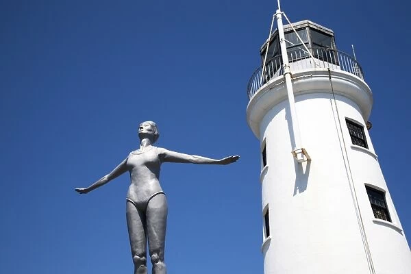 The Diving Belle Sculpture and Lighthouse on Vincents Pier, Scarborough, North Yorkshire, Yorkshire, England, United Kingdom, Europe