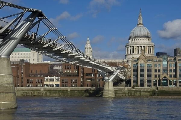 The Dome of St. Pauls Cathedral and Millennium Bridge over the River Thames