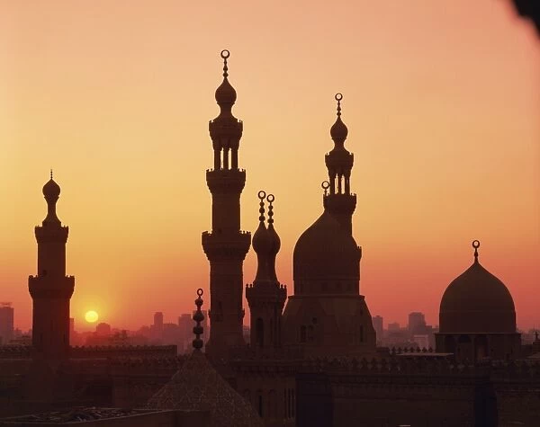 Domes and minarets silhouetted at sunset, Cairo, Egypt, North Africa, Africa