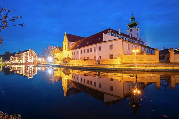 Dominican Monastery reflecting in Malse River at twilight, Ceske Budejovice, South Bohemian Region, Czech Republic (Czechia), Europe