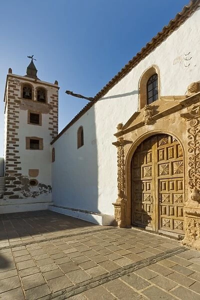 Door and belltower of the 17th century Santa Maria Cathedral in this historic former capital, Betancuria, Fuerteventura, Canary Islands, Spain, Europe