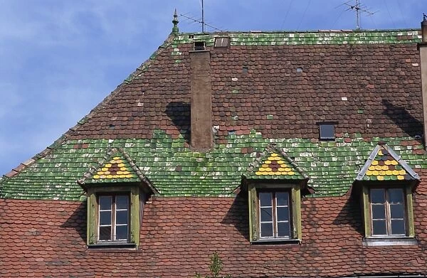 Dormer windows and decorative tiles on a typical roof in the old town of Ribeauville