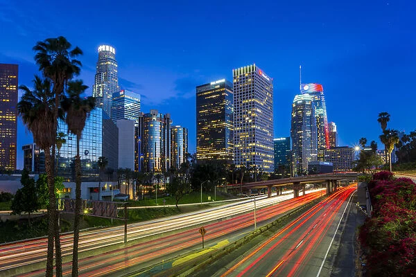 Downtown financial district of Los Angeles city and busy freeway at night, Los Angeles