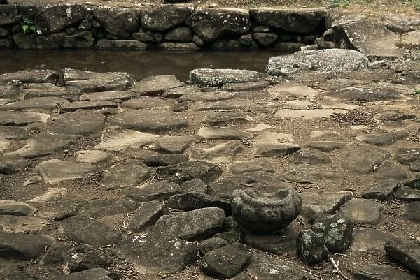 Drinking pool and decorated grinding stone at excavated site of pre-Columbian city