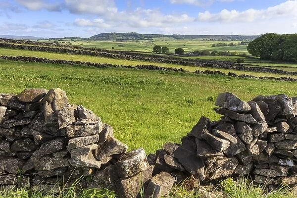 Dry stone wall, with view across a beautiful typical country landscape in spring