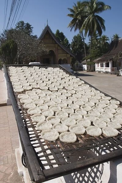 Drying rice cakes for monks, Luang Prabang, Laos, Indochina, Southeast Asia, Asia