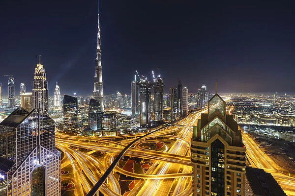 Dubai skyline and Sheikh Zayed Road Interchange by night, Dubai, United Arab Emirates