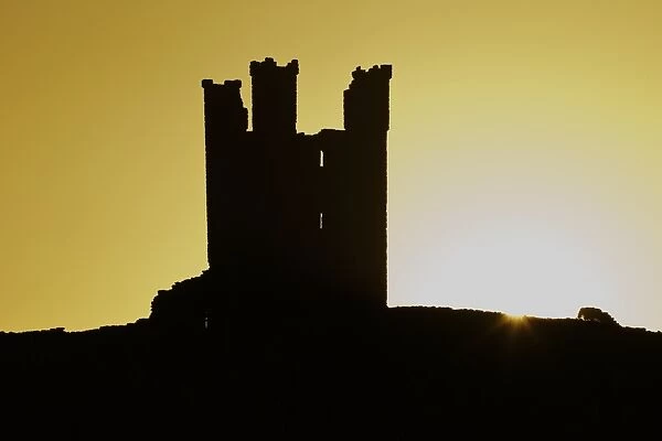 Dunstanburgh Castle at dawn, Northumberland, England, United Kingdom, Europe