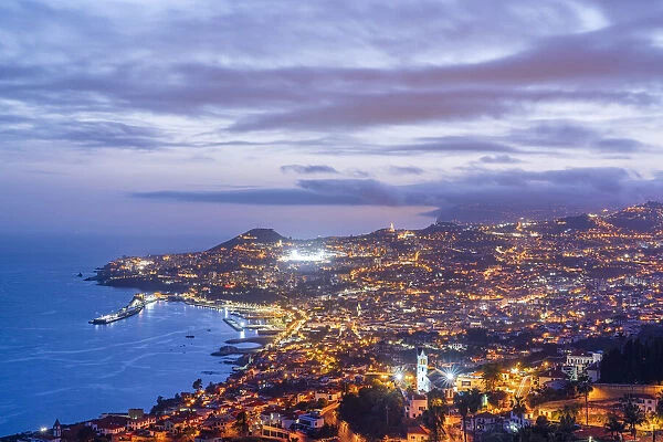 Dusk over the iIluminated city of Funchal viewed from Sao Goncalo, Madeira island