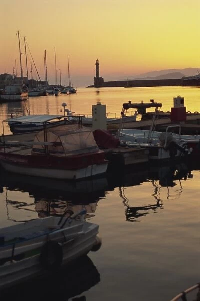 Dusk light over moored boats in the harbour and the