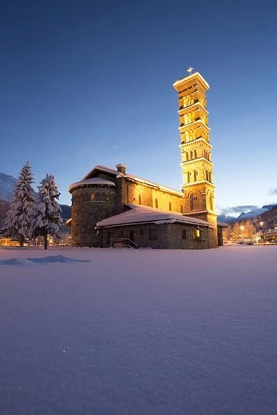 Dusk and lights on the church surrounded by snow Sankt Moritz, Engadine, Canton of Grisons
