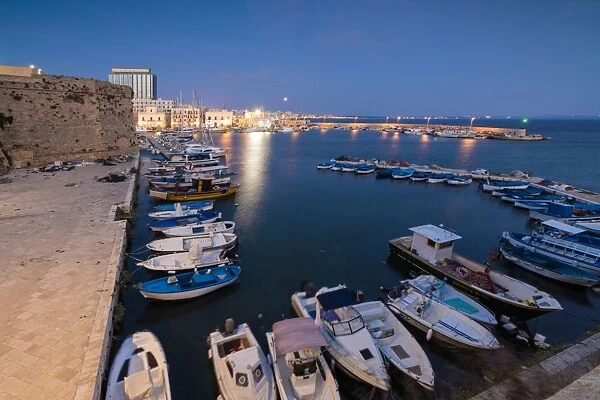 Dusk lights the harbor and the medieval old town of Gallipoli, Province of Lecce