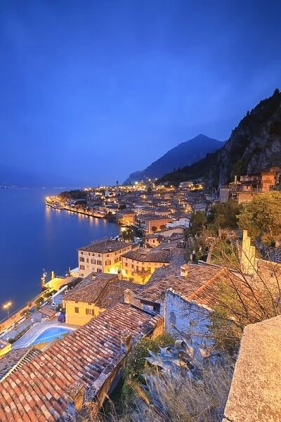Dusk lights up Lake Garda and the typical town of Limone Sul Garda, province of Brescia