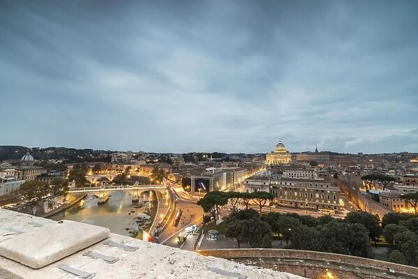 Dusk lights on Lungo Tevere with the Basilica di San Pietro in the background, Rome
