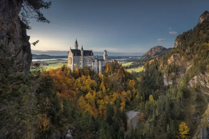 Framed Print : Dusk lights on Neuschwanstein Castle surrounded by colorful woods in autumn, Fussen Framed Print : Dusk lights on Neuschwanstein Castle surrounded by colorful woods in autumn, Fussen
