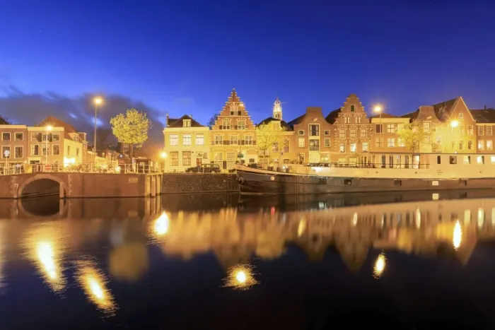 Framed Print : Dusk lights on typical houses and bridge reflected in a canal of the River Spaarne Framed Print : Dusk lights on typical houses and bridge reflected in a canal of the River Spaarne