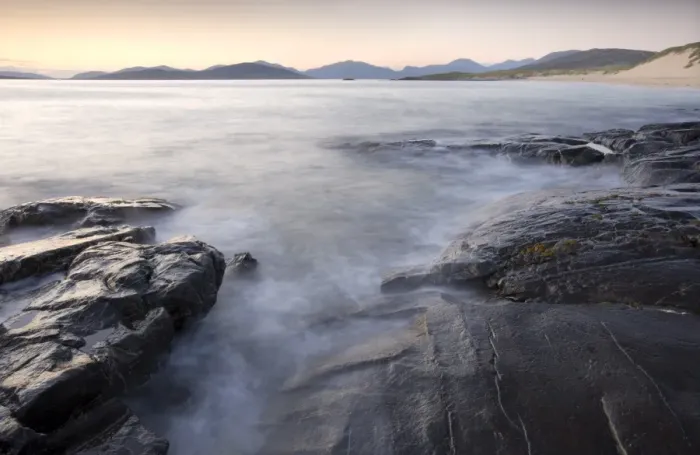 Framed Print : Dusk view across open water towards Taransay and North Harris from the rocky shore at Borve Framed Print : Dusk view across open water towards Taransay and North Harris from the rocky shore at Borve