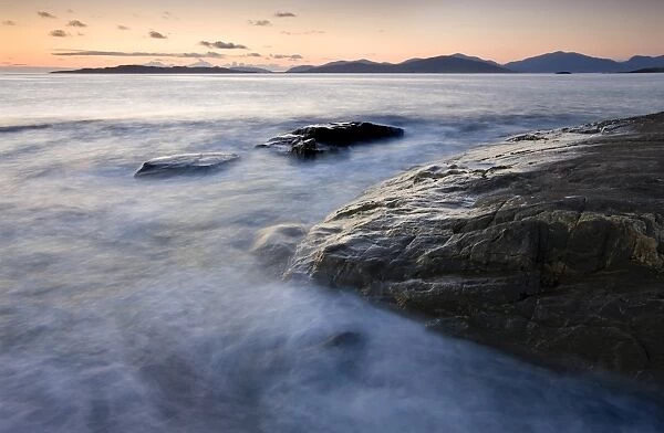 Dusk view towards Taransay and the Isle of hills of North Harris from Borve Beach