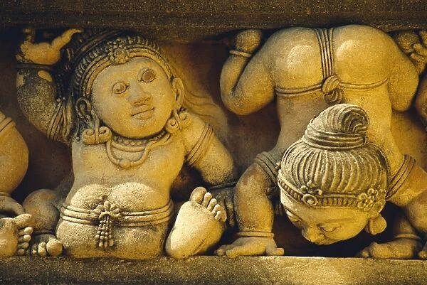 Dwarf carvings line temple wall