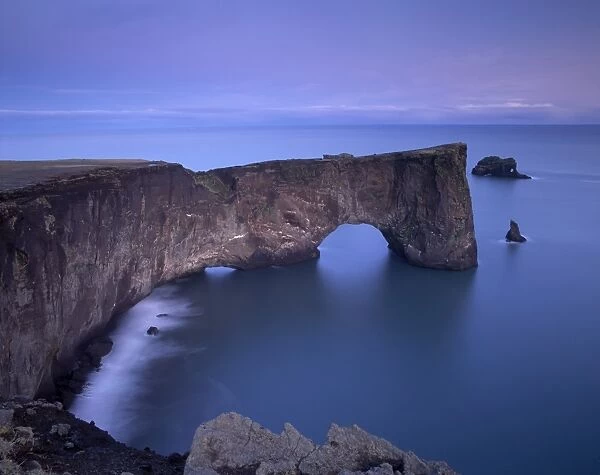 Dyrholaey natural arch, southernmost point in Iceland, at dusk, near Vik