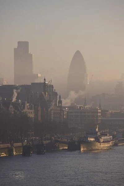 Early morning fog hangs over the City of London skyline, London, England