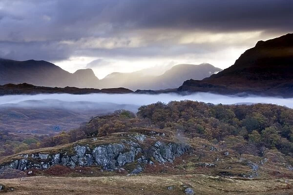 Early morning mist hanging over woodland and moorland near Loch Maree, Poolewe