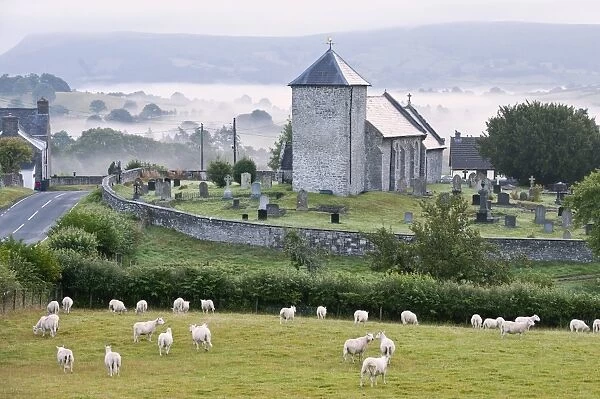 Early morning mist in the valleys surrounds St. Davids Church, Llanddewi r Cwm, Powys
