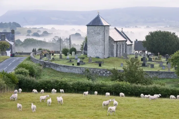 Framed Print : Early morning mist in the valleys surrounds St. Davids Church, Llanddewi r Cwm, Powys