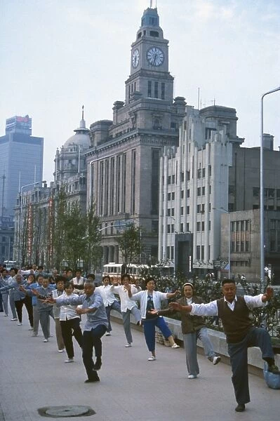 Early morning tai chi in front of old customs house, Shanghai, China, Asia