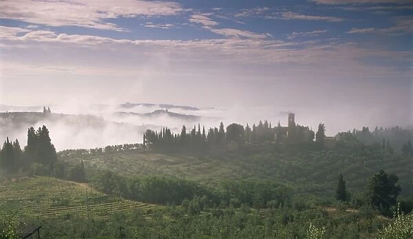 Early morning view across misty hills, near Certaldo, Tuscany, Italy, Europe