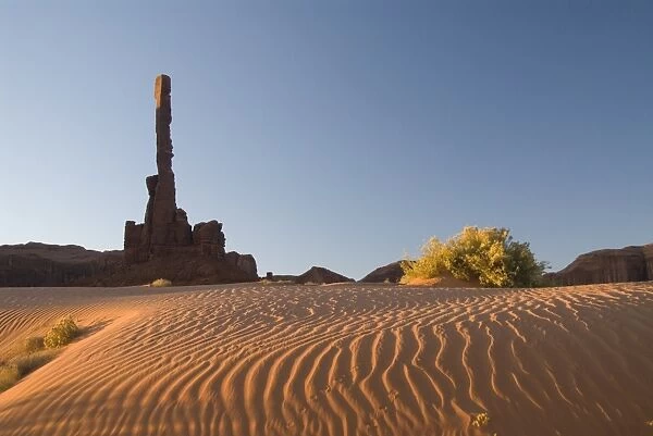 Early morning view of the Totem Pole with sand dunes in the foreground
