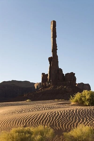 Early morning view of the Totem Pole with sand dunes in the foreground