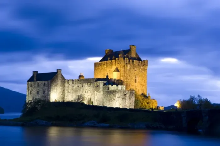 Framed Print : Eilean Donan Castle floodlit against deep blue twilight sky and water of Loch Duich Framed Print : Eilean Donan Castle floodlit against deep blue twilight sky and water of Loch Duich