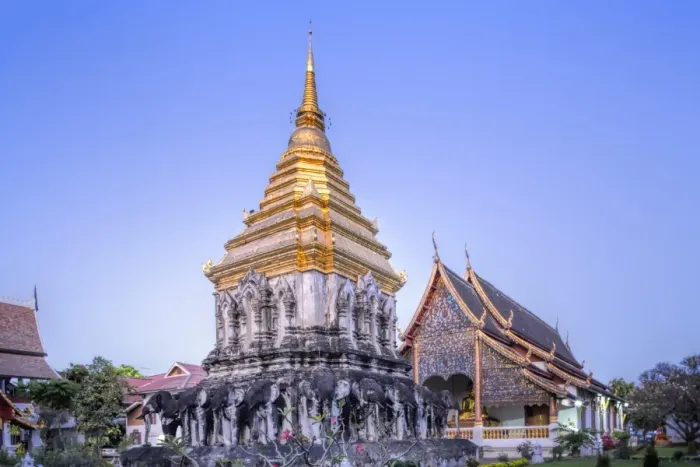 Framed Print : Elephant sculptures on the Chedi Chang Lom and the main bot at the temple of Wat Chiang Man Framed Print : Elephant sculptures on the Chedi Chang Lom and the main bot at the temple of Wat Chiang Man