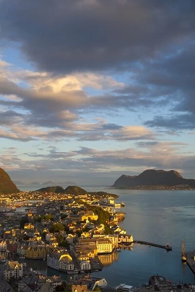 Elevated view over Alesund illuminated at sunset, Sunnmore, More og Romsdal, Norway, Scandinavia, Europe