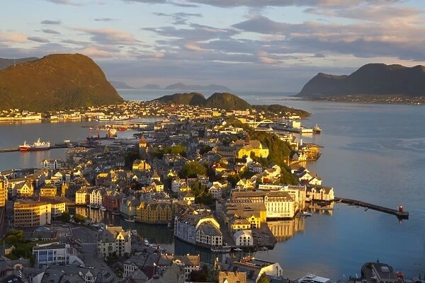 Elevated view over Alesund illuminated at sunset, Sunnmore, More og Romsdal, Norway, Scandinavia, Europe