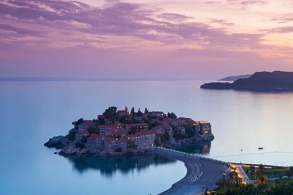 Elevated view over the picturesque island of Sveti Stephan illuminated at dusk, Sveti Stephan, Montenegro, Europe